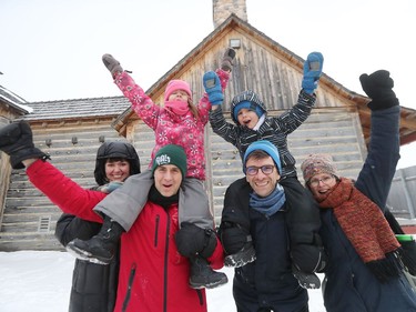 L-R: Heather Blewettt, Matt Blewett (holding four-year-old Madelyn on his shoulders), Michael Pereira (holding four-year-old Elliot Pereira Hildebrandt on his shoulders) and Amber Hildebrandt give their best 'He Ho' while attending Festival du Voyageur on Louis Riel Day in Winnipeg, Man., on Monday, Feb. 15, 2020. The 51st annual Festival du Voyageur in Winnipeg, Man., runs from Feb. 14 to 23, 2020.