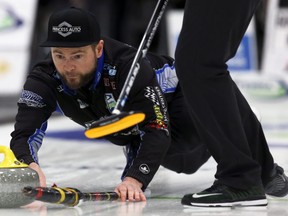 Skip Mike McEwen delivers a stone during the Manitoba men's curling championship final at Eric Coy Arena in Winnipeg, Feb. 9, 2020.