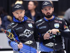 Mike McEwen (left) and Reid Carruthers talk strategy during last year’s Viterra provincial men’s curling championship in Virden, Man. (KEVIN KING/WINNIPEG SUN FILES)