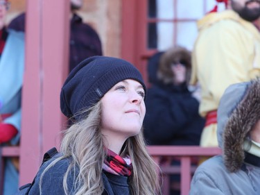 Minnedosa, Man., resident Jill Huyghe watches the reenactment of the Red River Skirmish between La Compagnie de La Vérendrye and the Forces of Lord Selkirk inside Fort Gilbraltar on the final day of the 51st annual Festival du Voyageur in Winnipeg, Man., on Sunday, Feb. 23, 2020.