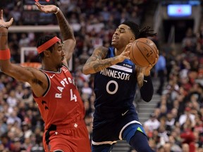 Timberwolves guard D'Angelo Russell (0) is fouled by Raptors forward Rondae Hollis-Jefferson (4) during first half NBA action at Scotiabank Arena in Toronto, Monday, Feb. 10, 2020.