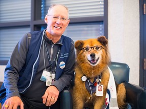 Rusty the therapy dog was a fixture at St. Boniface Hospital in Winnipeg for a decade before retiring this past November. His owner George Ames, left, said he died on Tuesday, Feb. 18, 2020. Supplied