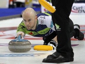 In this Jan. 28, 2020, file photo, third Ryan Fry of the John Epping rink throws a rock during the Tankard Provincial Championship in Cornwall, Ont.