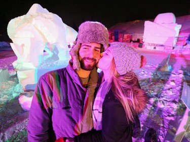 St. Andrews resident Jessica Medgyes gives her boyfriend Todd Schreuders a kiss on Valentine's Day while the couple stands in front of a snow sculpture at Festival du Voyageur in Winnipeg, Man., on Friday, Feb. 14, 2020. The 51st annual Festival du Voyageur runs from Feb. 14 to 23, 2020.