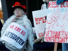 Protestors stand outside the Ministry of Environment as part of a protest against the Coastal GasLink pipeline, in Victoria, British Columbia, Canada February 14, 2020.