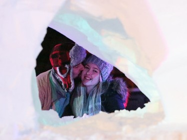 Todd Schreuders gives his girlfriend Jessica Medgyes a kiss while the duo look through a snow sculpture at Festival du Voyageur in Winnipeg, Man., on Friday, Feb. 14, 2020. The 51st annual Festival du Voyageur runs from Feb. 14 to 23, 2020.
