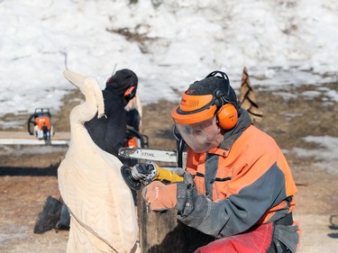 Walter Keller carves a great blue heron as he participates in the wood carving challenge on the final day of the 51st annual Festival du Voyageur in Winnipeg, Man., on Sunday, Feb. 23, 2020.