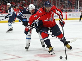 WASHINGTON, DC - FEBRUARY 25: Alex Ovechkin #8 of the Washington Capitals skates past Dmitry Kulikov #7 of the Winnipeg Jets during the second period at Capital One Arena on February 25, 2020 in Washington, DC.