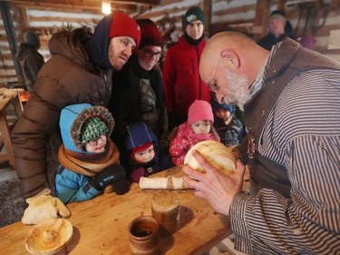 Wood carver Pedro Bedard talks about making a wooden bowl to visitors at at Festival du Voyageur on Louis Riel Day in Winnipeg, Man., on Monday, Feb. 17, 2020. The 51st annual Festival du Voyageur in Winnipeg, Man., runs from Feb. 14 to 23, 2020.