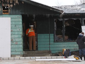 A home in the 500 block of Grassie Boulevard in Winnipeg that was the scene of a fatal fire on Sunday is boarded up on Monday.