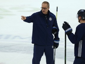 Head coach Paul Maurice (left) speaks with Jack Roslovic during Winnipeg Jets practice at Bell MTS Place on Monday.