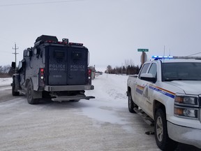RCMP vehicles, including the Emergency Response Team, outside of a residence near Dauphin, Man., on Tuesday, where an armed 29-year-old man barricaded himself for almost nine hours before surrendering without incident.