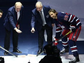 Thomas Steen (centre left) and Randy Carlyle (centre right) perform the ceremonial puck drop between New York Rangers forward Chris Kreider (left) and Winnipeg Jets captain Blake Wheeler following a ceremony to honour the 2020 Winnipeg Jets Hall of Fame inductees in Winnipeg on Tuesday. Kevin King/Winnipeg Sun/Postmedia Network