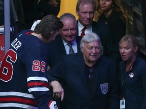 Winnipeg Jets captain Blake Wheeler (left) welcomes Bobby Hull (right) and team Hall of Fame members-to-be Randy Carlyle (second left) and Thomas Steen (top right) prior to facing New York Rangers in Winnipeg on Tuesday.