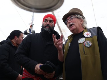 Rolly Gagne (right) talks maple taffy with federal New Democratic Party leader Jagmeet Singh, who celebrated Louis Riel Day at Festival du Voyageur in Winnipeg with Manitoba NDP leader Wab Kinew (left) on Mon., Feb. 17, 2020. Kevin King/Winnipeg Sun/Postmedia Network