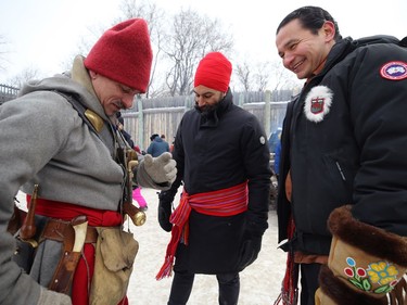 Voyageur Louis Gagne (left) describes his kit to federal New Democratic Party leader Jagmeet Singh (centre) and Manitoba NDP leader Wab Kinew as the two leaders celebrate Louis Riel Day at Festival du Voyageur in Winnipeg on Mon., Feb. 17, 2020. Kevin King/Winnipeg Sun/Postmedia Network