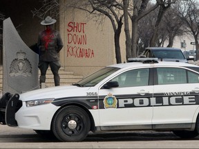 A Winnipeg Police Service cruiser sits in front of the graffiti-strewn RCMP 'D' Division headquarters on Portage Avenue in Winnipeg on Wed., Feb. 26, 2020. Kevin King/Winnipeg Sun/Postmedia Network