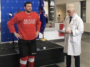 Dr. Anthony Albina (a McGill University resident), left, and Dr. Scott Delaney demonstrate the new concussion test developed by Delaney and his researchers.