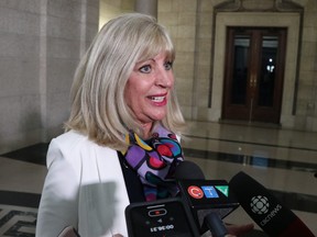 Sport, Culture and Heritage Minister Cathy Cox addresses the public during an unveiling of 20 awards for women who have made outstanding contributions to the advancement of gender equality during a ceremony at the Manitoba Legislature in Winnipeg on Monday.