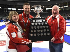 Team Newfoundland and Labrador skip Brad Gushue and his mother Maureen and father Ray take pictures with the the Brier Tankard after defeating Team Alberta in the Brier final in Kingston, Ont., on Sunday, March 8, 2020.