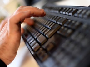 A person types on a keyboard