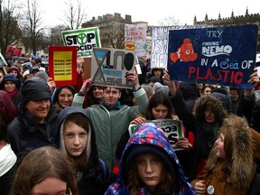 Young demonstrators hold placards as they attend a "Youth Strike 4 Climate" protest in Bristol, south west England on February 28, 2020.