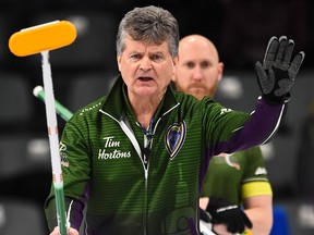 Team Prince Edward Island skip Bryan Cochrane calls the sweep as Team Northern Ontario skip Brad Jacobs, back looks on at the Brier in Kingston, Ont., on Sunday, March 1, 2020.