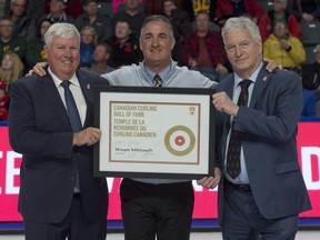 Wayne Middaugh is formally inducted into the Canadian Curling Hall of Fame by Curling Canada board members John Shea (right) and George Cooke. (Michael Burns/CURLING CANADA)