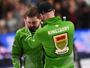 Team Saskatchewan skip Matt Dunstone, gets a hug from coach Adam Kingsbury as he reacts to a 7-6 loss to Team Newfoundland skip Brad Gushue in the Brier semifinal in Kingston, Ont., on Sunday, March 8, 2020.