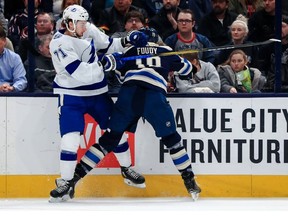 Tampa Bay Lightning center Anthony Cirelli (71) checks Columbus Blue Jackets center Liam Foudy (19) in the first period at Nationwide Arena.