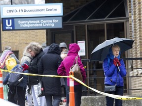 People wait in line to enter the COVID-19 Assessment Centre at Sunnybrook Hospital in Toronto on Tuesday March 17, 2020. Stan Behal/Toronto Sun