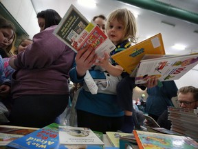 Ashley Greenfeld has her hands full as her 2 1/2-year-old son Hymie checks out book titles during the Family Literacy Fun Day at Lord Roberts Community Centre in Winnipeg on Sun., March 1, 2020. Kevin King/Winnipeg Sun/Postmedia Network