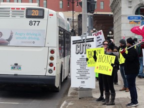 People protesting against presumed cuts coming the city budget on Friday demonstrate outside City Hall in Winnipeg on Monday. The Amalgamated Transit Union, Budget for All Winnipeg, and Functional Transit Winnipeg said they were behind the effort.