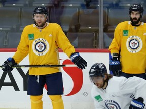Mark Letestu (left) and Mathieu Perreault watch during Winnipeg Jets practice at Bell MTS Place on Mon., March 2, 2020. Kevin King/Winnipeg Sun/Postmedia Network
