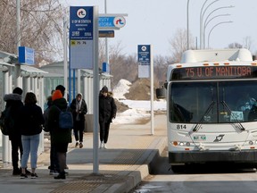 A Winnipeg Transit bus approaches a stop on the University of Manitoba campus.