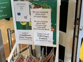 Signs inside of a Sobeys grocery store in Winnipeg on Saturday, informing customers that the store was limiting purchases of toilet paper items and had limited or no stock of other items. Customers have been greeted with long lines and empty shelves at stores across the city.