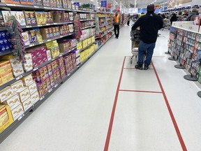 Superstore has marked their floors to assist people in maintaining an appropriate distance between one another while waiting for the check out.  This is the location on St.James Street, in Winnipeg. Chris Procaylo/Winnipeg Sun file