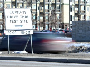 A vehicle passes a sign for the drive-thru COVID-19 testing site on Barnes Street in south Winnipeg on Wednesday, March 25. As of Friday, an additional 435 laboratory tests were performed at Cadham Provincial Laboratory. This brings the total number of tests performed since early February to 22,598.