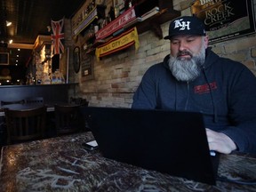 King's Head Pub owner Chris Graves works on a plan to start a grocery delivery service out of its King Street location in Winnipeg on Mon., March 30, 2020. Kevin King/Winnipeg Sun/Postmedia Network