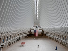 A man walks alone through the nearly empty Oculus transportation hub at the World Trade Center in lower Manhattan, during the outbreak of the coronavirus disease (COVID-19) in New York City, New York, U.S., April 20, 2020.