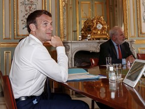 French President Emmanuel Macron, left, takes part in a videoconference with G7 leaders on coordination of the COVID-19 pandemic response at the Elysee presidential Palace in Paris on April 16, 2020 as his Chief of Military Staff Admiral Bernard Rogel, right, attend. (GONZALO FUENTES/POOL/AFP via Getty Images)
