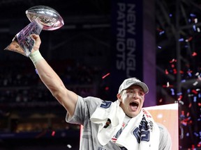 New England Patriots tight end Rob Gronkowski holds up the Vince Lombardi Trophy after his team defeated the Seattle Seahawks in the NFL Super Bowl XLIX football game in Glendale, Arizona, February 1, 2015.