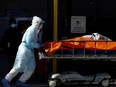 A healthcare worker wheels the body of a deceased person from the Wyckoff Heights Medical Center during the outbreak of the coronavirus disease (COVID-19) in the Brooklyn borough of New York City, New York, U.S., April 4, 2020.