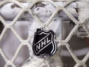 In this file photo taken Sept. 17, 2012, the NHL logo is seen on a goal at a Nashville Predators practice rink in Nashville, Tenn.