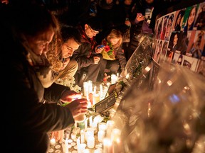 Mourners light candles for the victims of Ukrainian Airlines Flight 752 which crashed in Iran during a vigil at Mel Lastman Square in Toronto on Jan. 9, 2020.