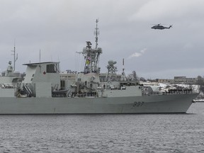 A Cyclone helicopter flies over HMCS Fredericton as its crew leaves the Halifax Harbour for a six-month deployment to the Mediterranean Sea as part of NATO's Operation Reassurance in Halifax on Monday, Jan. 20, 2020.
