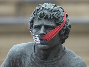 The statue of Terry Fox opposite Parliament Hill was adorned with a makeshift face mask.