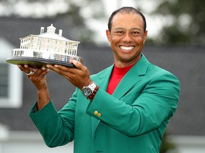 Tiger Woods of the U.S. celebrates with with his green jacket and trophy after winning the 2019 Masters. (REUTERS/Lucy Nicholson/File Photo)