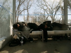 Frontline workers who deal with the most vulnerable members of the community do not have adequate personal protective equipment.  Many vulnerable people are currently spending their days and nights in bus shelters, like these two people on Tache Avenue.   Saturday, April 04/2020 Winnipeg Sun/Chris Procaylo/stf