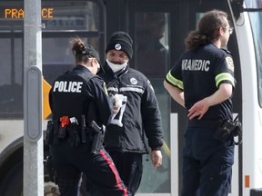Bus drivers, police and paramedics continue to work in close contact with members of the public, and with one another in Winnipeg on Tuesday April 7, 2020. Chris Procaylo/Winnipeg Sun